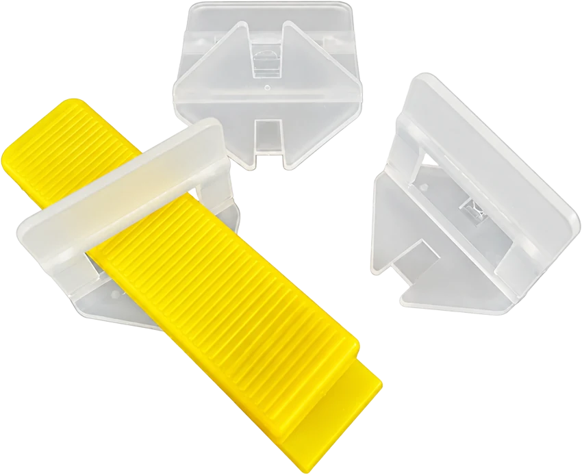 Tile leveling clips with a yellow wedge on a transparent background. Photo.